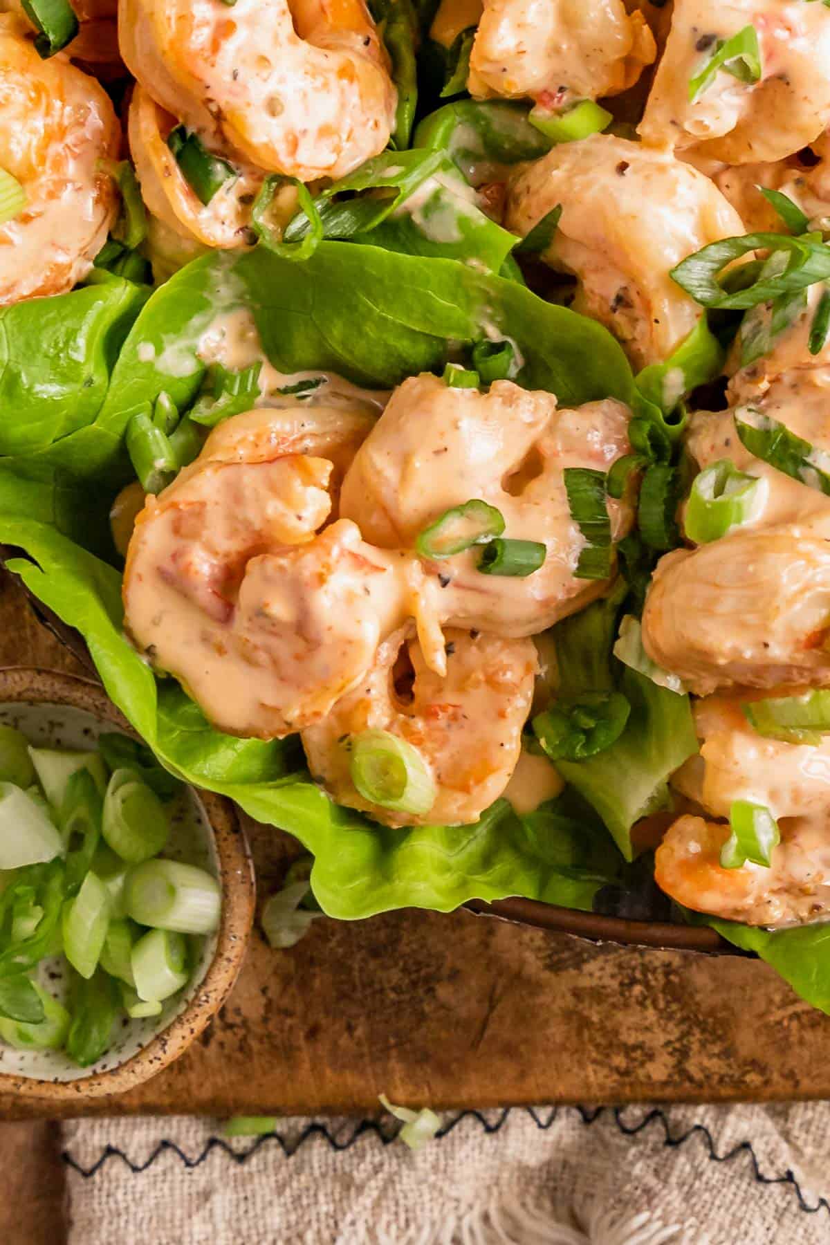 a close up showing bang bang sauce on shrimp lettuce wraps.