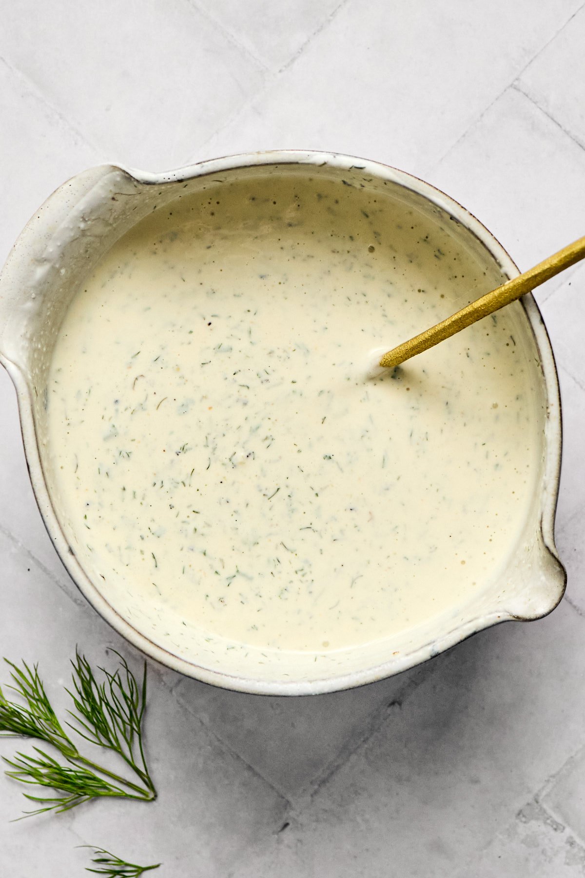 keto ranch dressing in a small bowl with a gold spoon