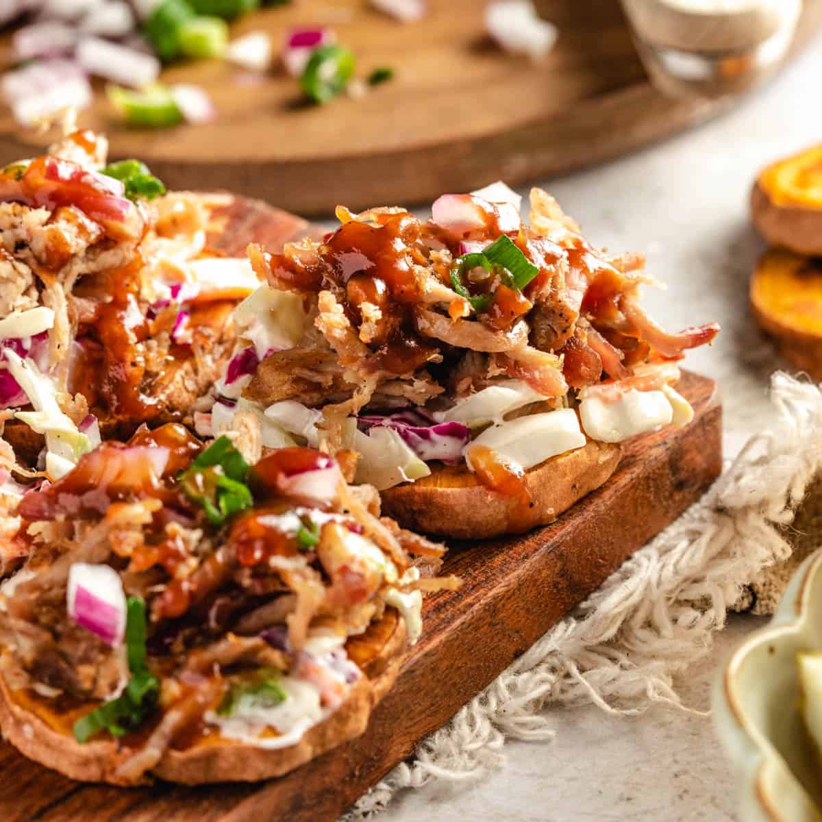 pulled pork topped on a sliced sweet potato