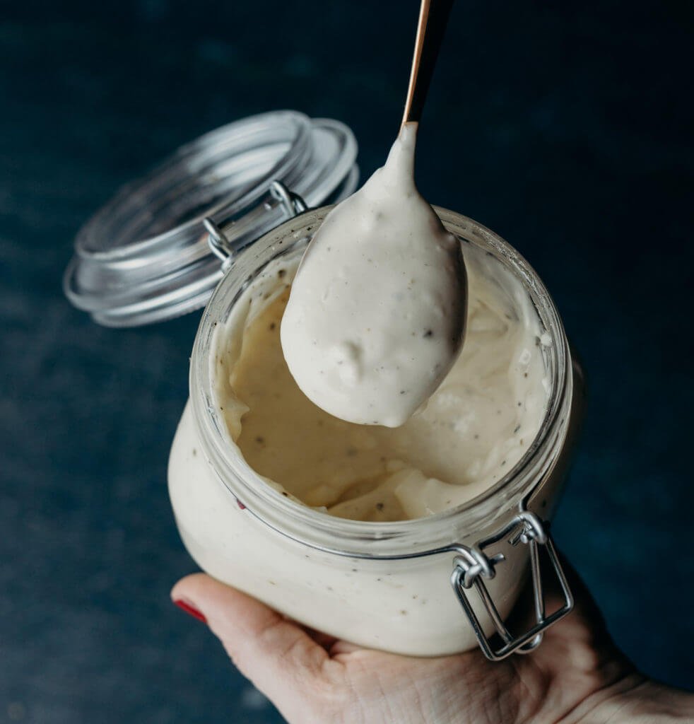 a glass jar filled with awesome sauce with a silver spoon showing a closeup spoonful