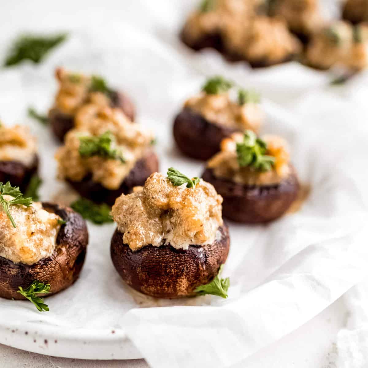 Close-up photo of keto stuffed mushrooms on a serving platter.