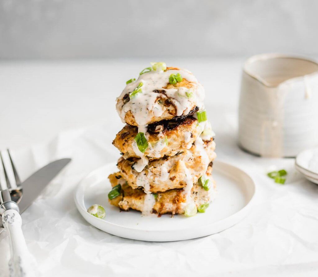 A stack of chicken patties drenched in spicy ranch. 