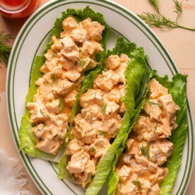 buffalo chicken salad on top of three pieces of lettuce