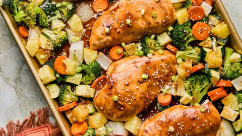 baked chicken and veggies on a sheet pan