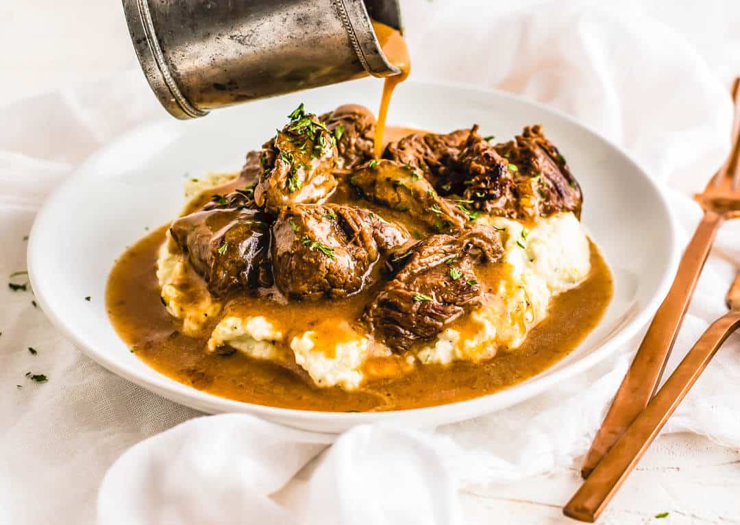 keto beef tips and gravy on a bed of mashed potatoes