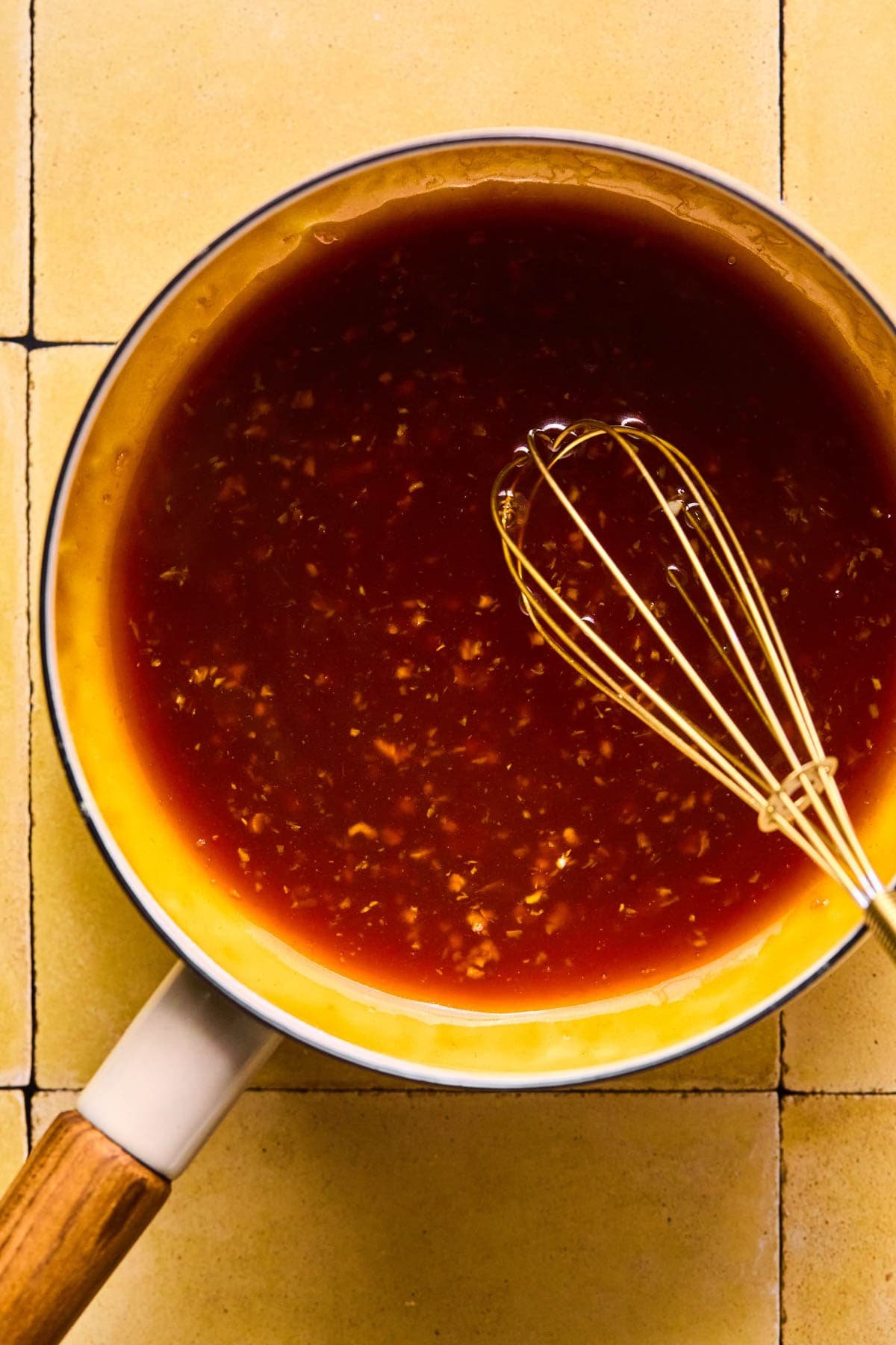 Asian meatballs sauce ingredients in a saucepan.