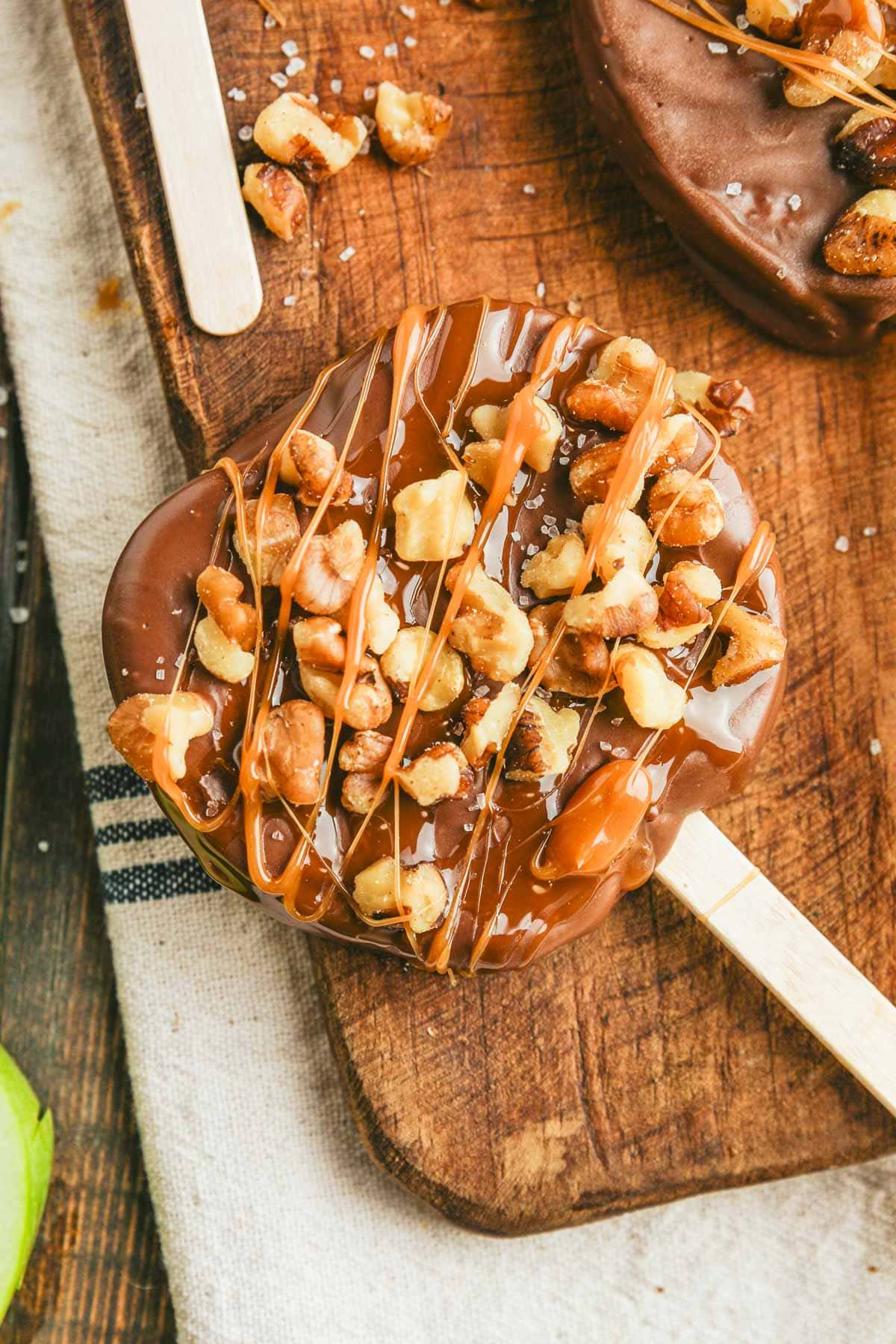 a close up of the chocolate caramel apple slices on a cutting board