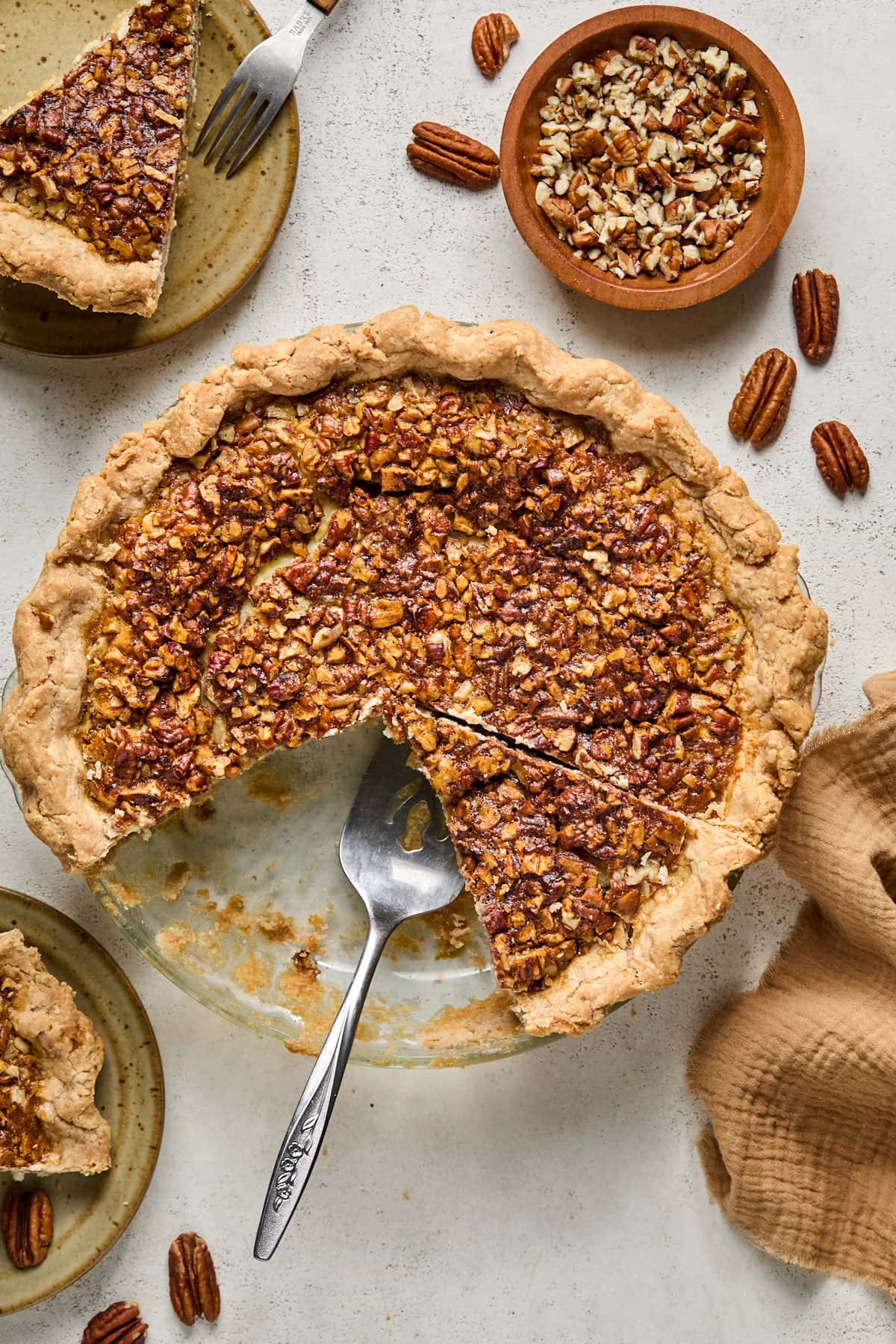 a serving spoon lifting a slice of pie out of a plate. 