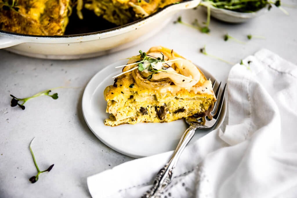 Steak & Onion Frittata on a white plate with a silver fork