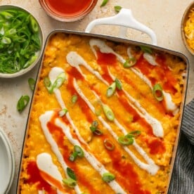 an overhead shot of a buffalo chicken casserole in a white dish