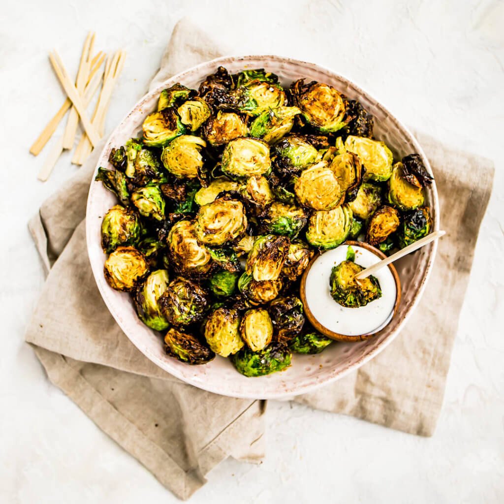 Air Fryer Brussels Sprouts dipped in ranch dressing