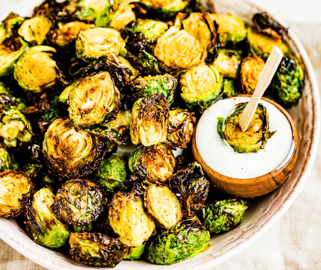 Air Fryer Brussels Sprouts dipped in ranch dressing