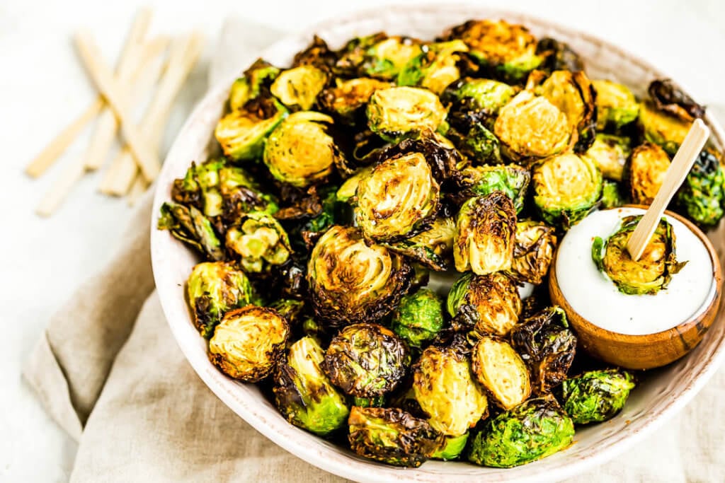 Air Fryer Brussels Sprouts dipped in ranch dressing