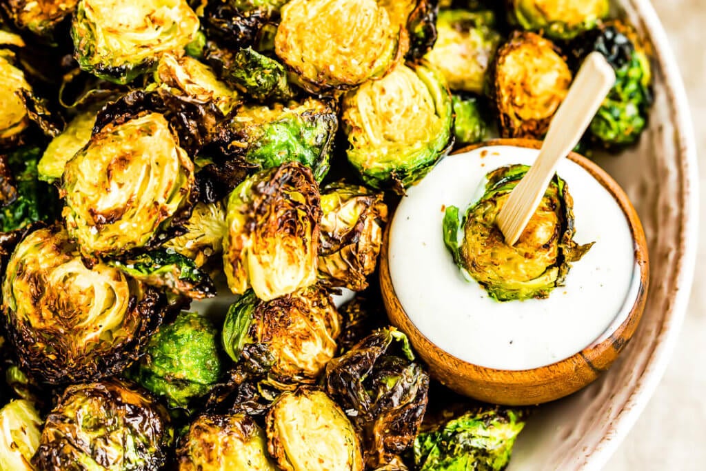 Air Fryer Brussels Sprouts dipped in ranch dressing