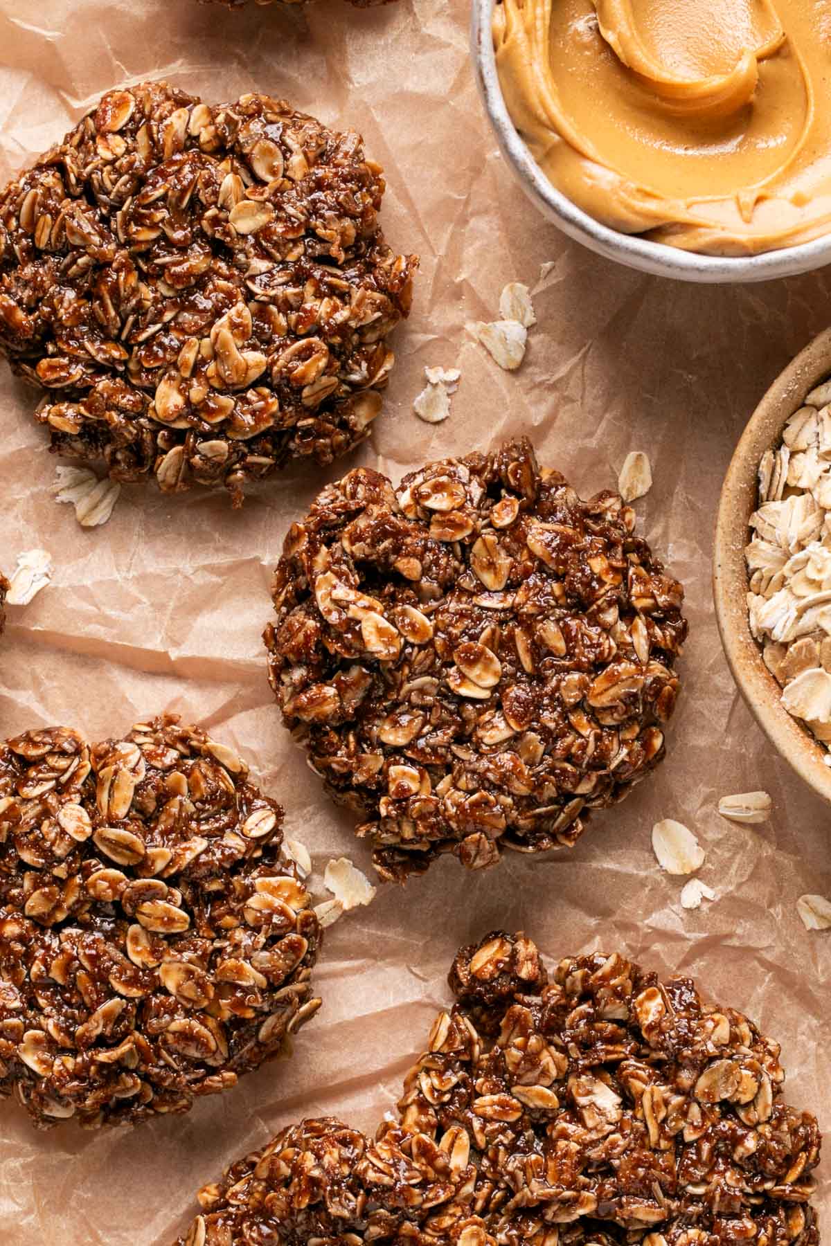 an overhead shot of protein cookies next to a bowl of peanut butter and oats