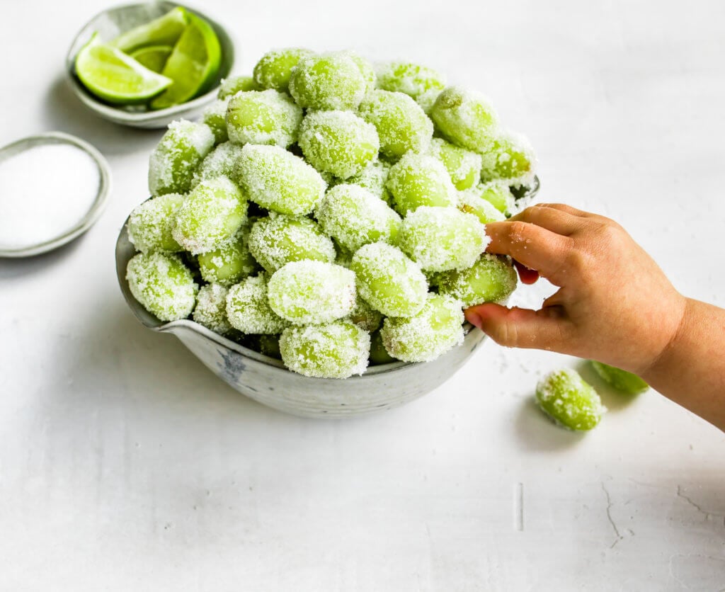 sour candy frozen grapes in a silver bowl