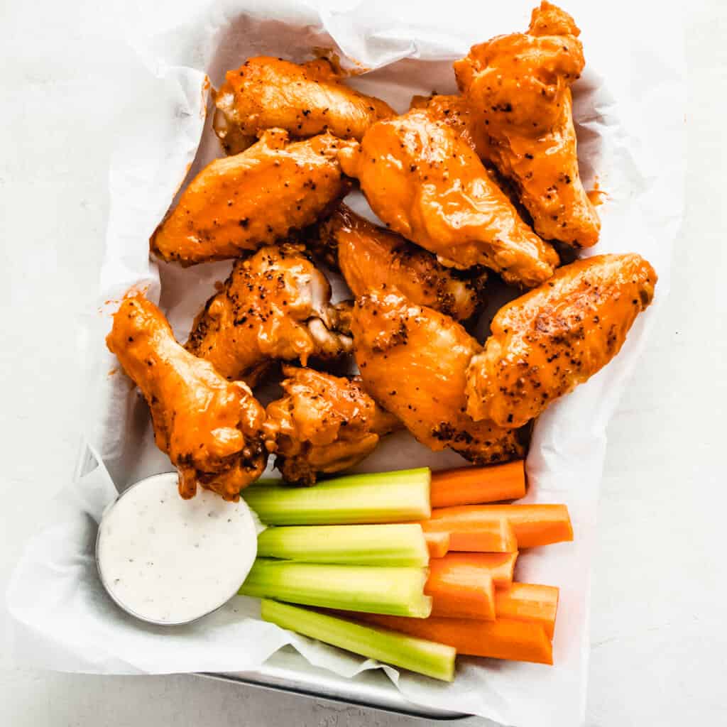 Chicken wings tossed in buffalo sauce with ranch dressing and carrots and celery. 