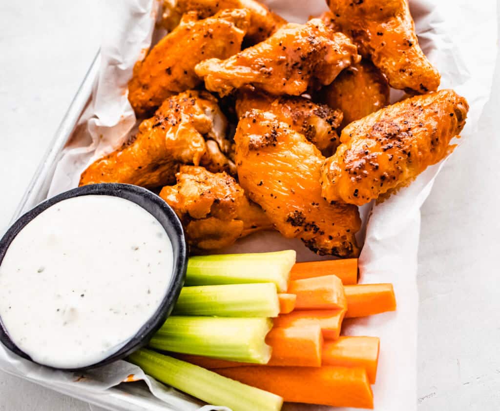 Chicken wings tossed in buffalo sauce with ranch dressing and carrots and celery. 
