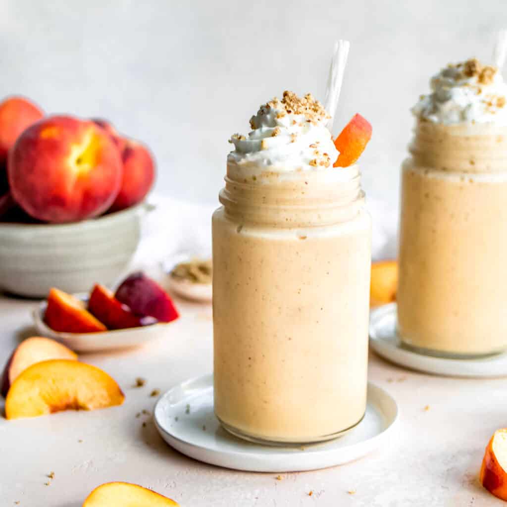Peaches and Cream Smoothie with whipped cream and pecan crisp topping