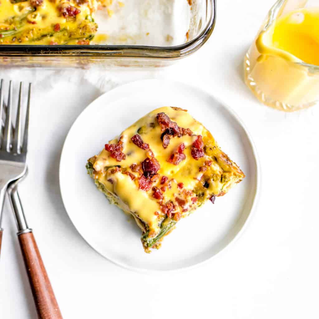 A slice of eggs Benedict casserole on top of plate with fork