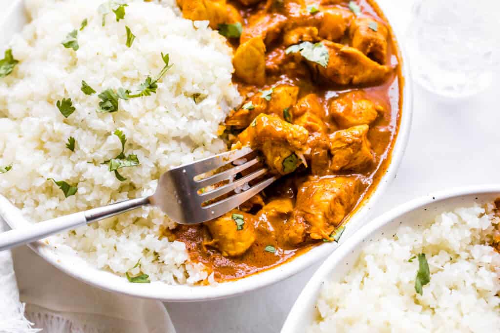 A close up shot of the instant pot butter chicken and cauliflower rice