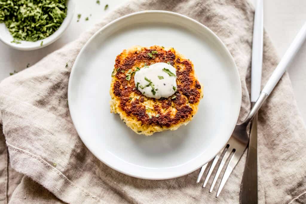 A circle tray of fritters made out of cauliflower and homemade ranch dressing