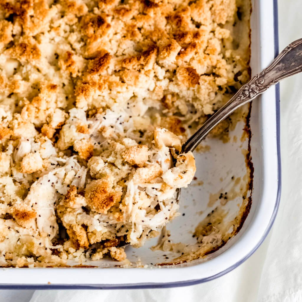 A large tray of chicken with poppyseeds, and crispy topping