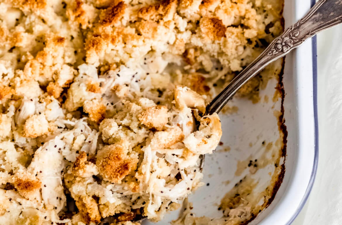 A large tray of chicken with poppyseeds, and crispy topping