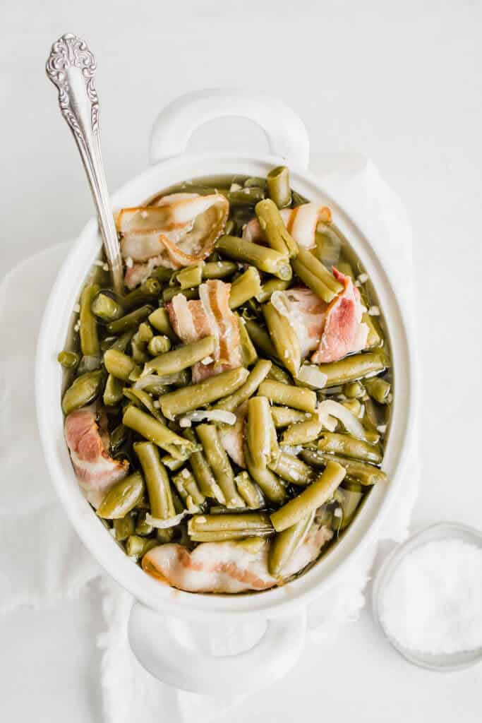 Green beans with bacon in a bowl with a spoon