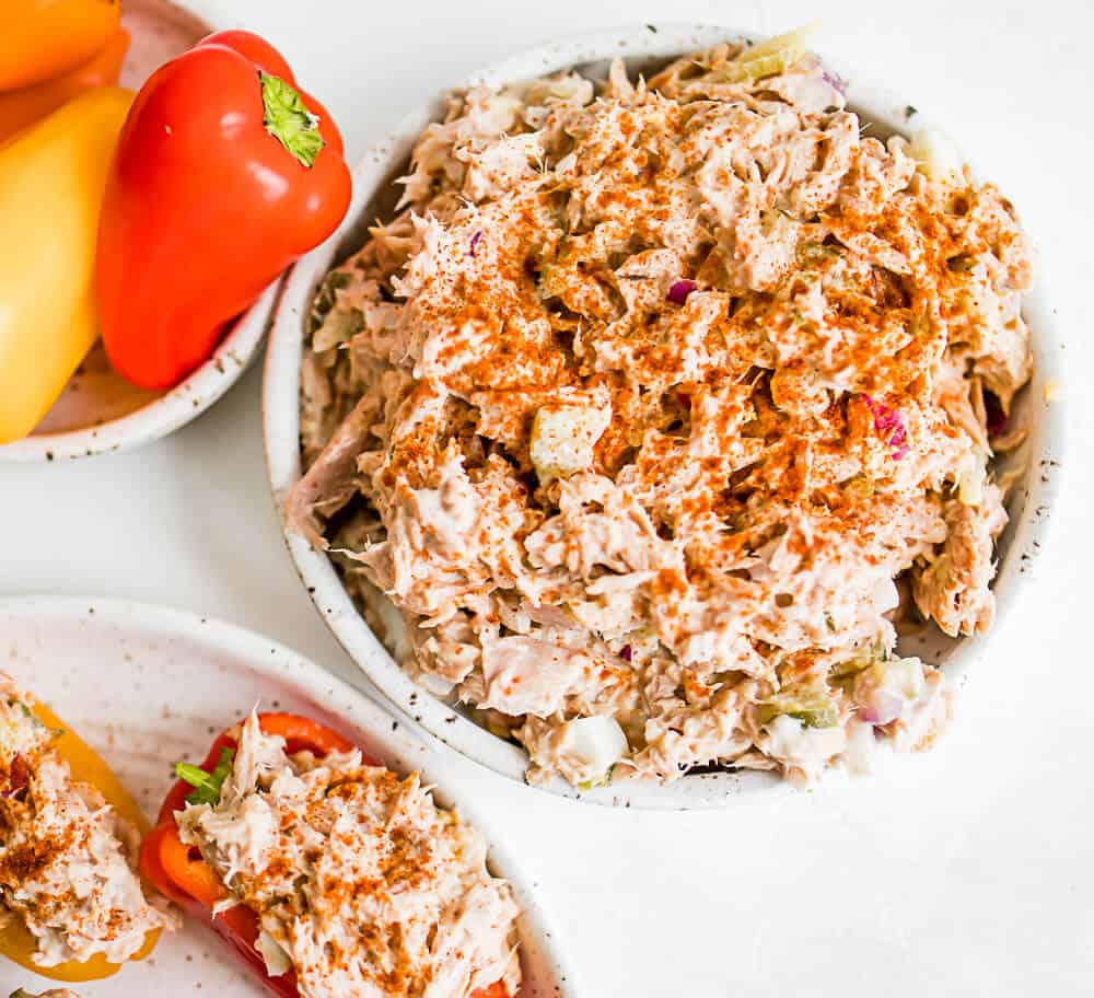 bowl of tuna salad with peppers around it