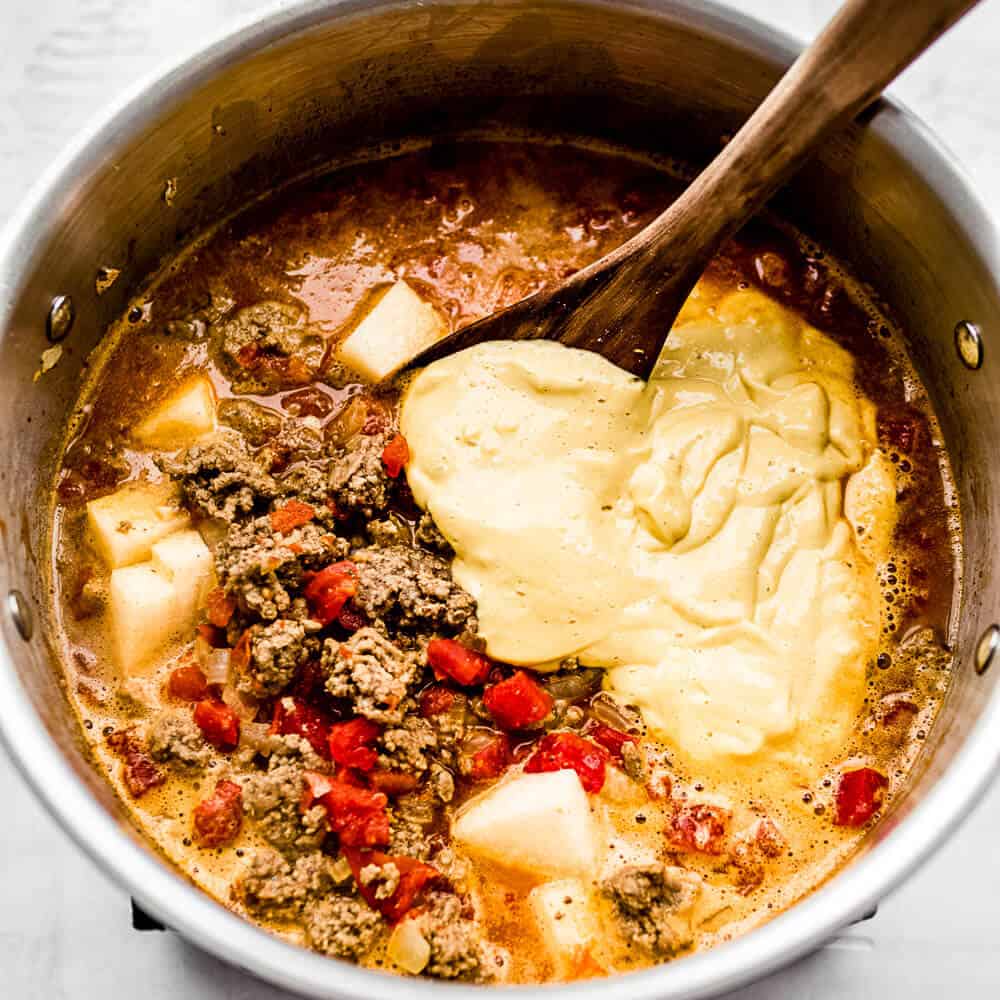 A close up photo of the soup and ingredients in the pot