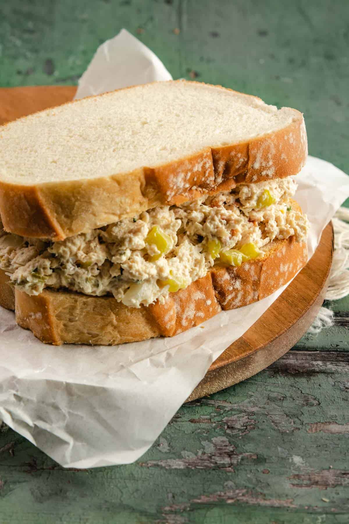chicken salad in between two slices of white sandwich bread