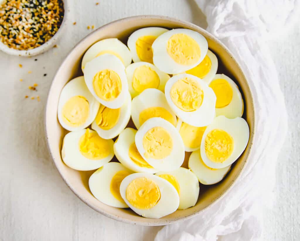 macro-friendly snack, hard boiled eggs sliced in half in a bowl