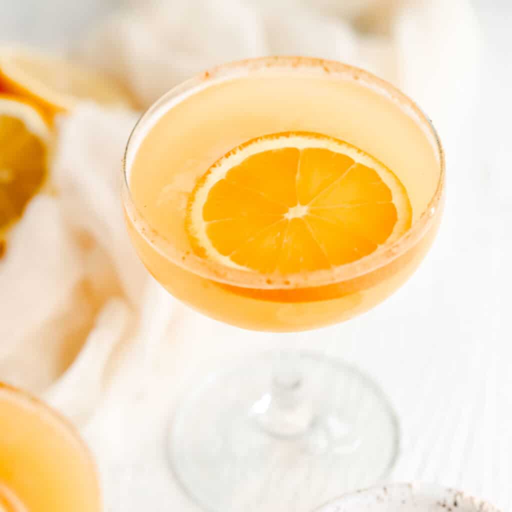 An up close photo of the drink with an orange slice