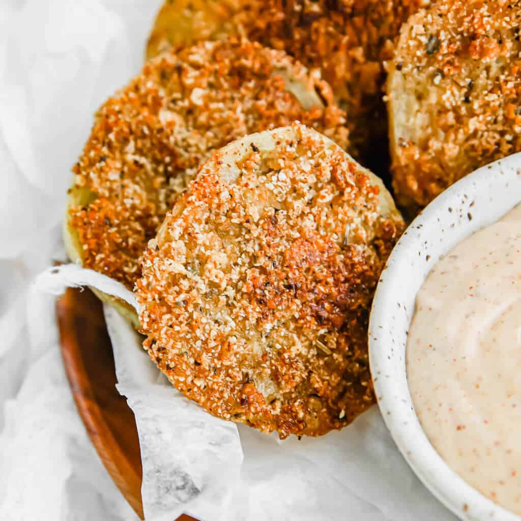 Keto Fried Green Tomatoes on a platter with sauce