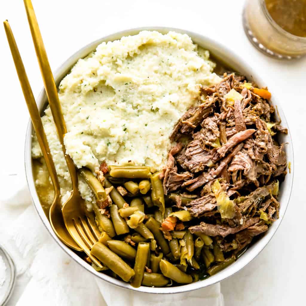 a overhead shot of cauliflower mash, green beans and roast