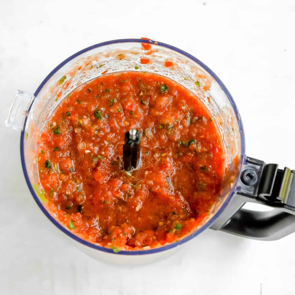 salsa in a food processor waiting for added lime and addition spice if needed 