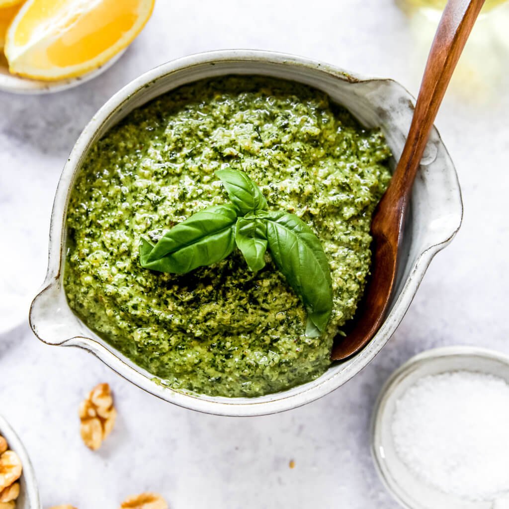 Pesto in a bowl garnished with basil