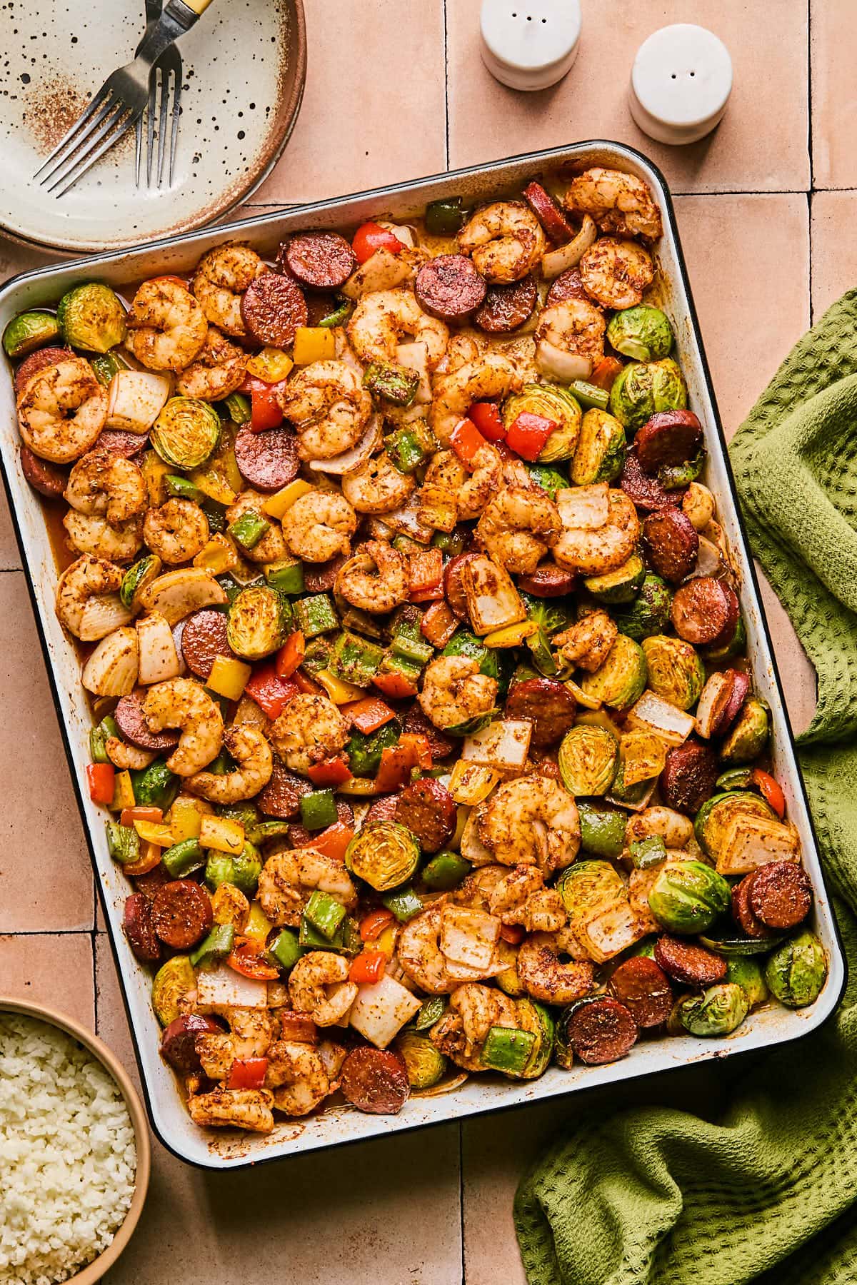cajun shrimp and sausage baked on a sheet pan with veggies and seasoning