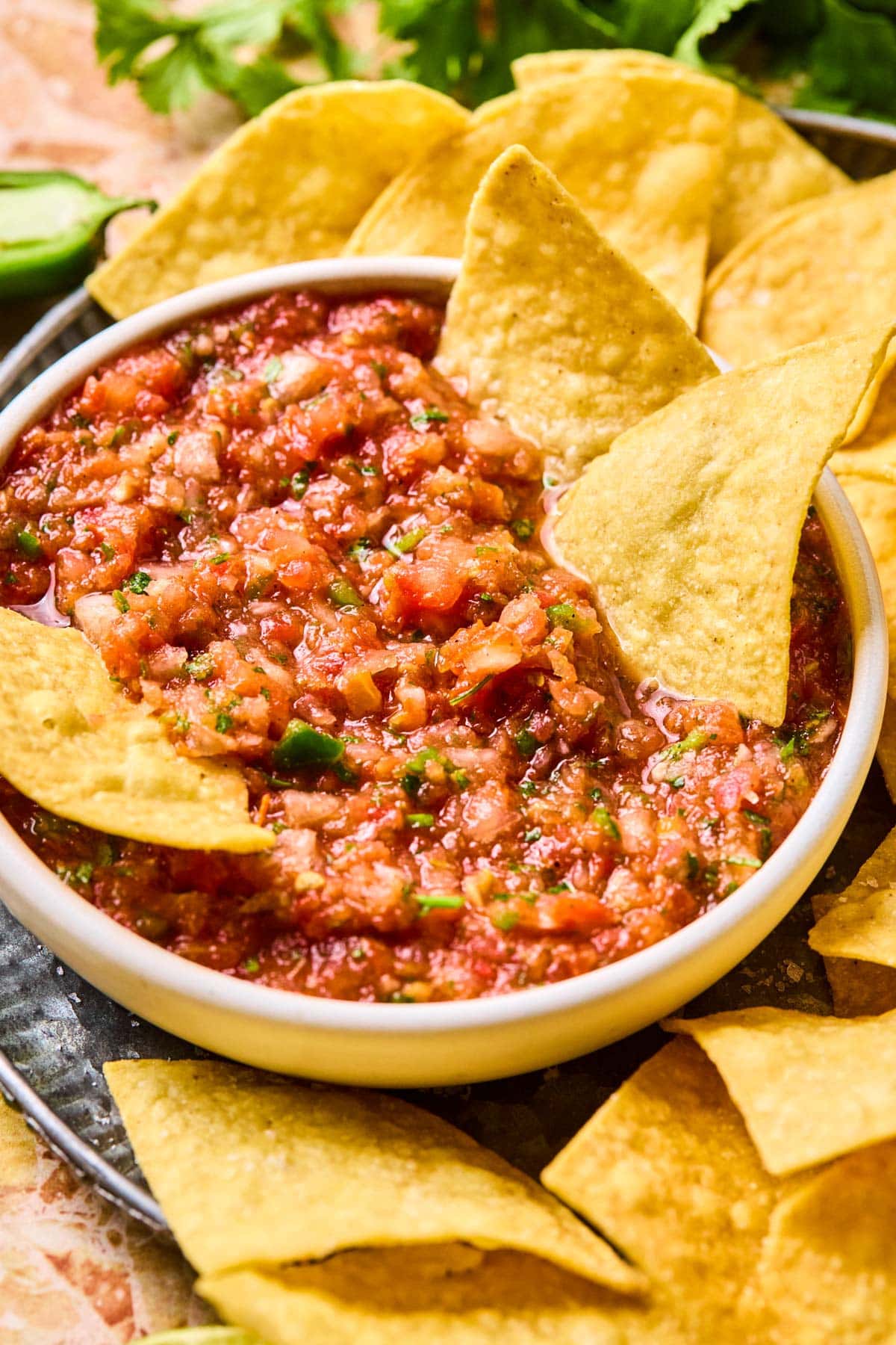 Garden fresh salsa served in a bowl with tortilla chips on the side, ready for dipping.