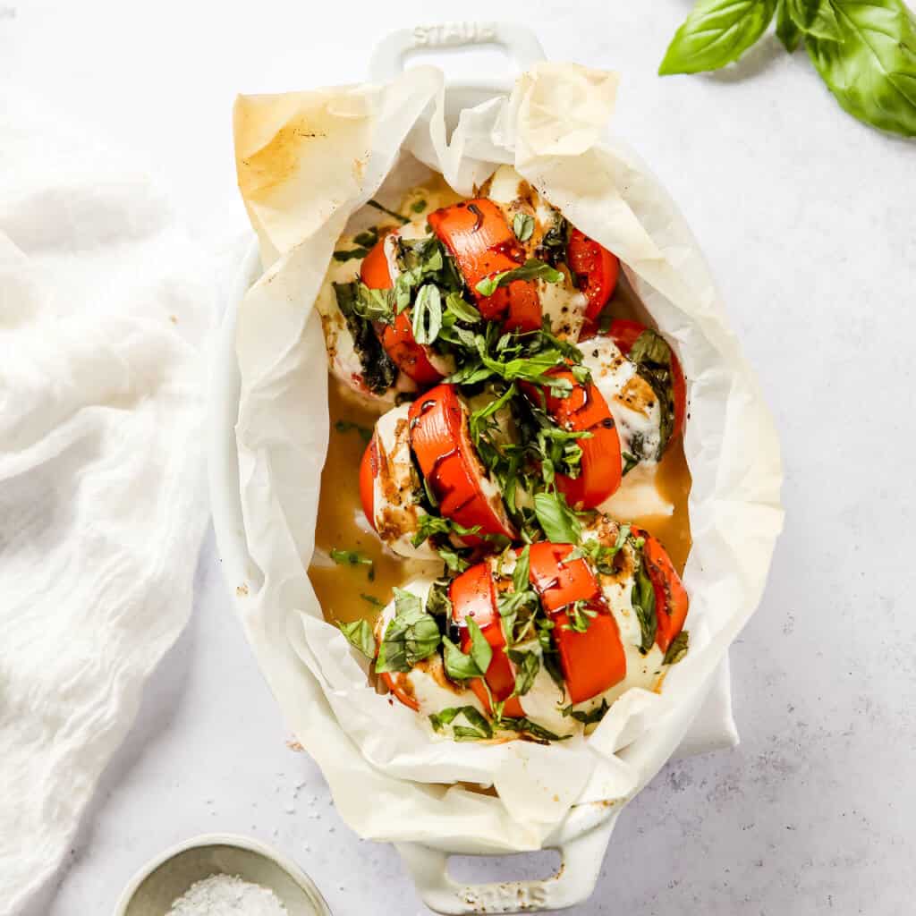 Caprese Salad in a tomato baked with cheese melted on top