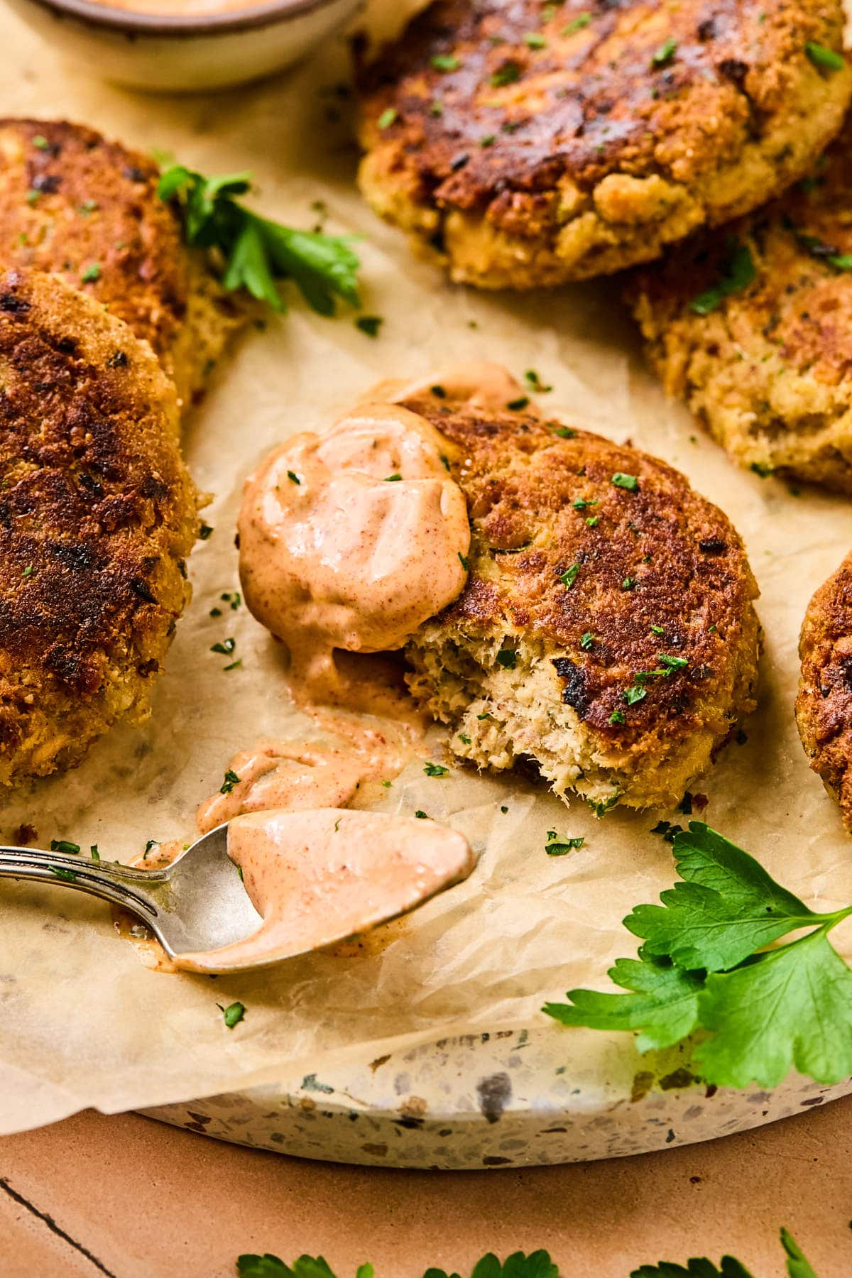 remoulade sauce on top of a salmon patty