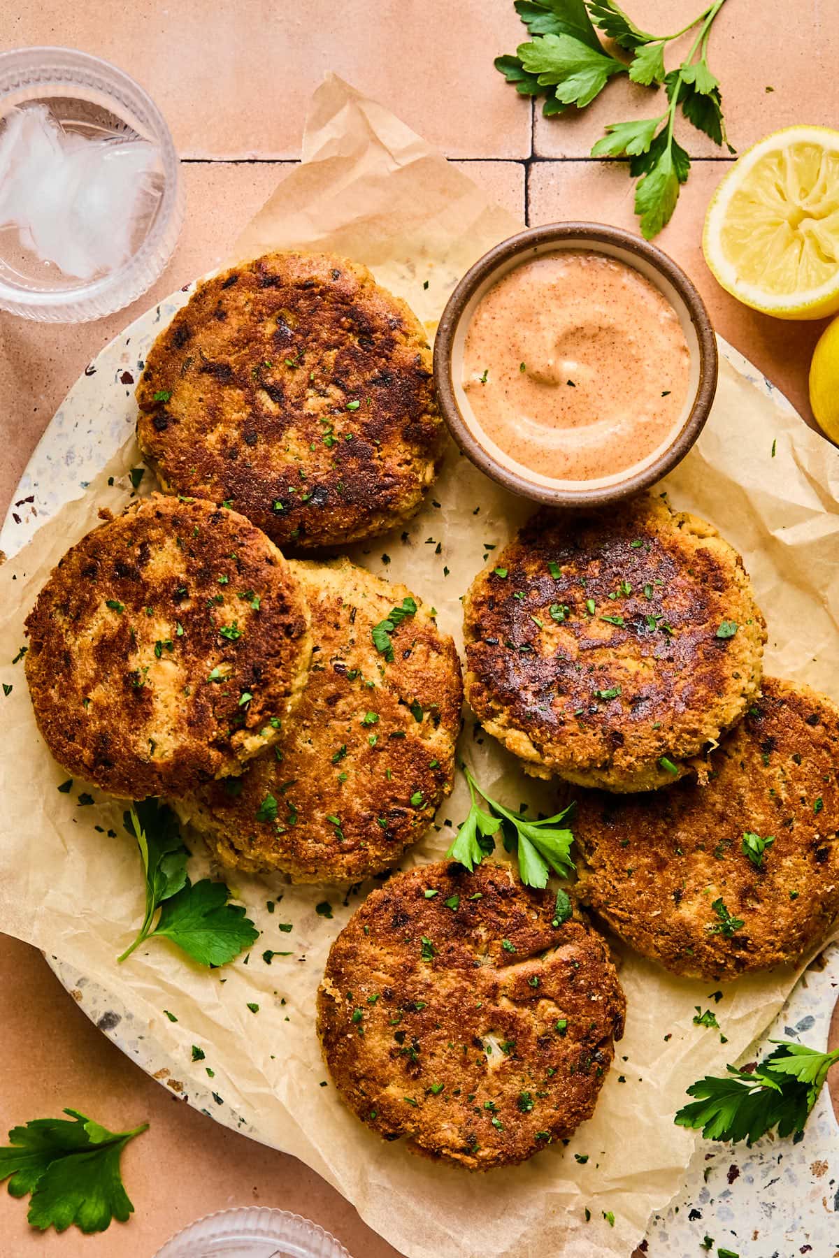 salmon cakes on parchment paper with dipping sauce 