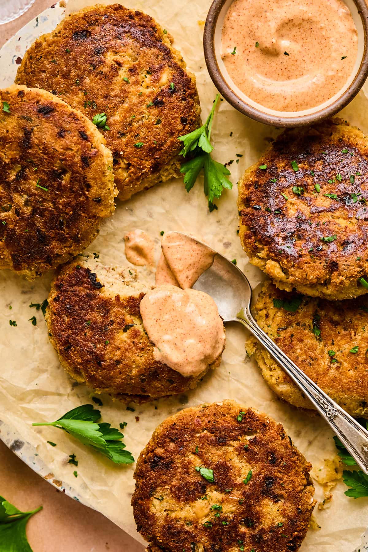 a close up shot of salmon patties with a dollop of sauce on top