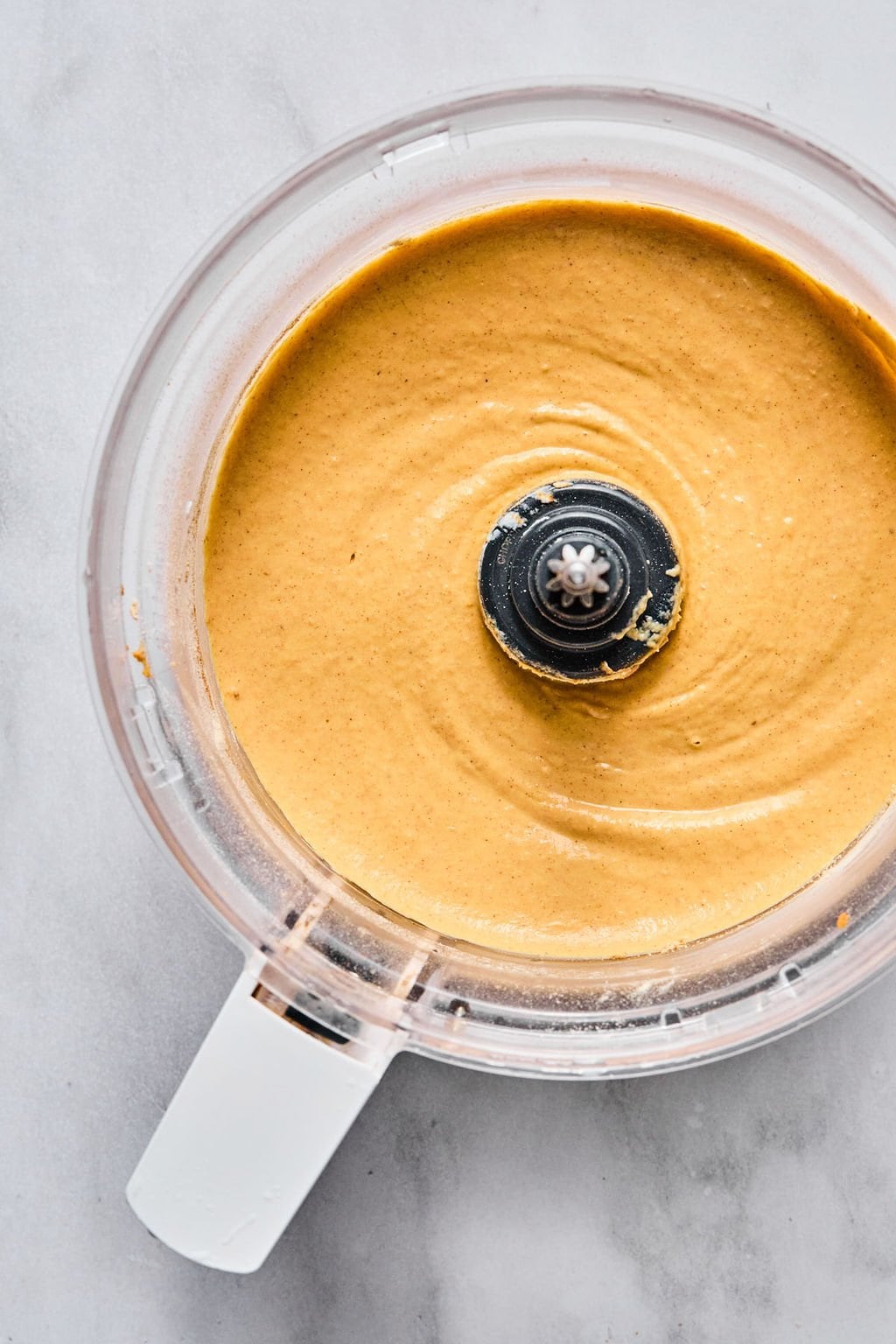 Pumpkin dip ingredients blended until smooth and silky, ready to chill.