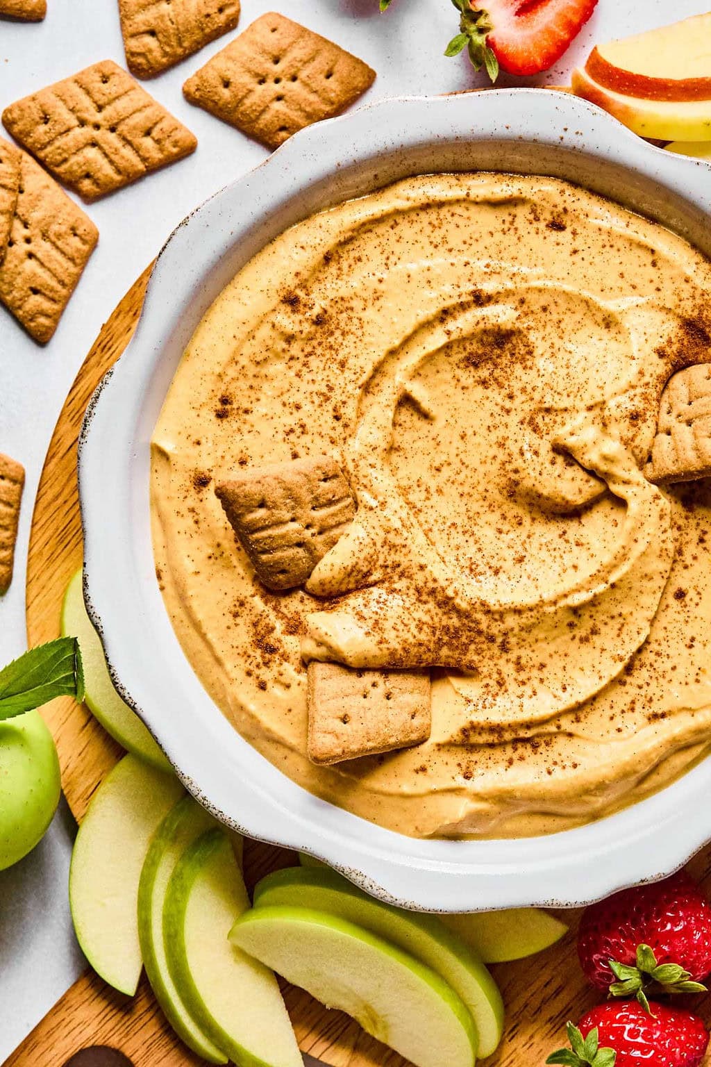 Close-up of fluffy, cinnamon-topped pumpkin dip showing creamy texture and warm pumpkin spice specks.