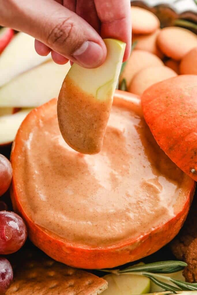 pumpkin dip with an apple dipped in it