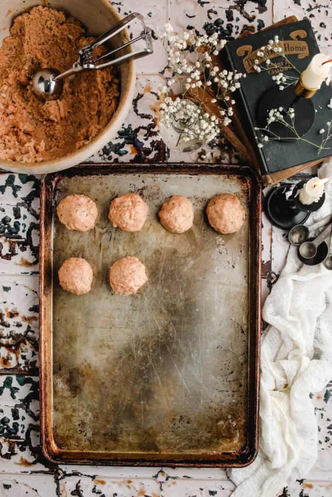 chicken meatballs on a greased baking sheet