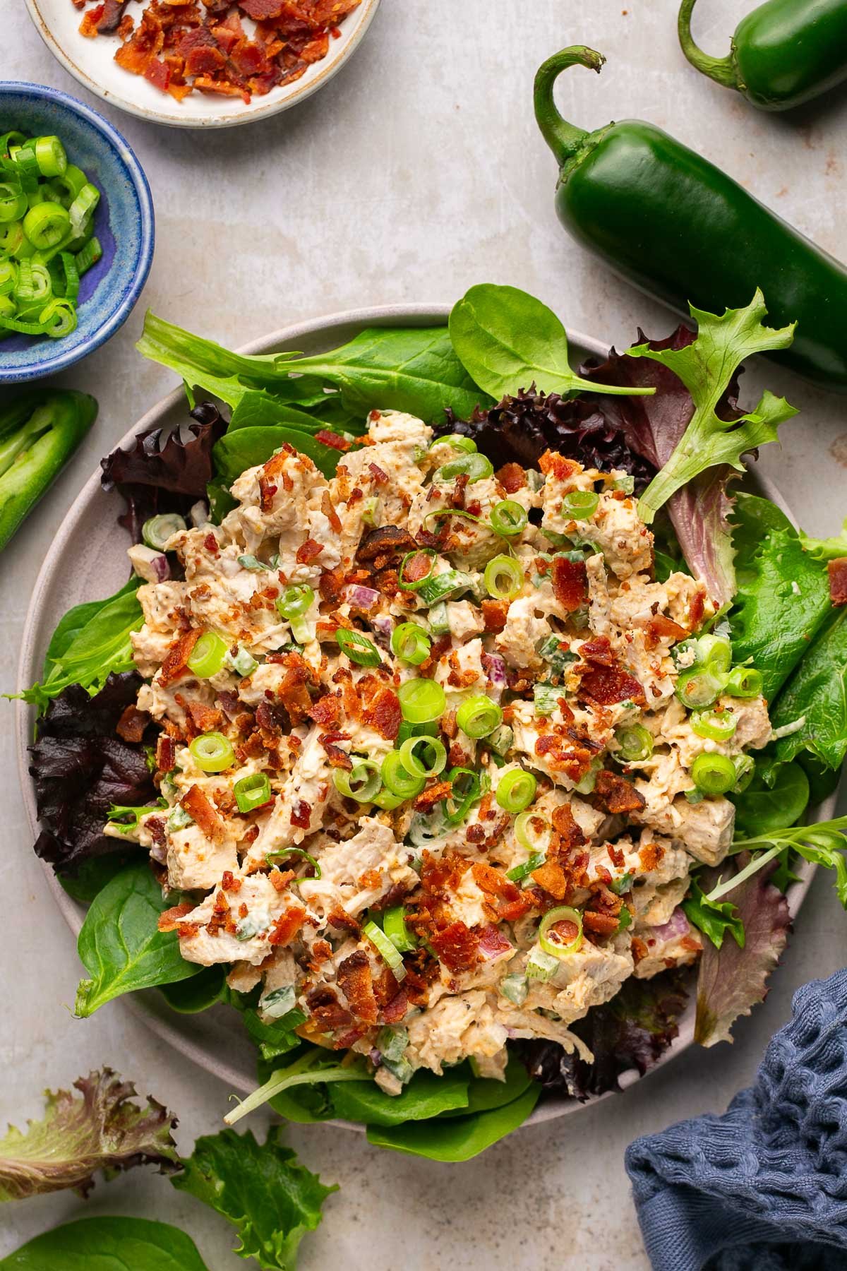  Chicken Salad over a bed of greens and chopped green onion and bacon over the top