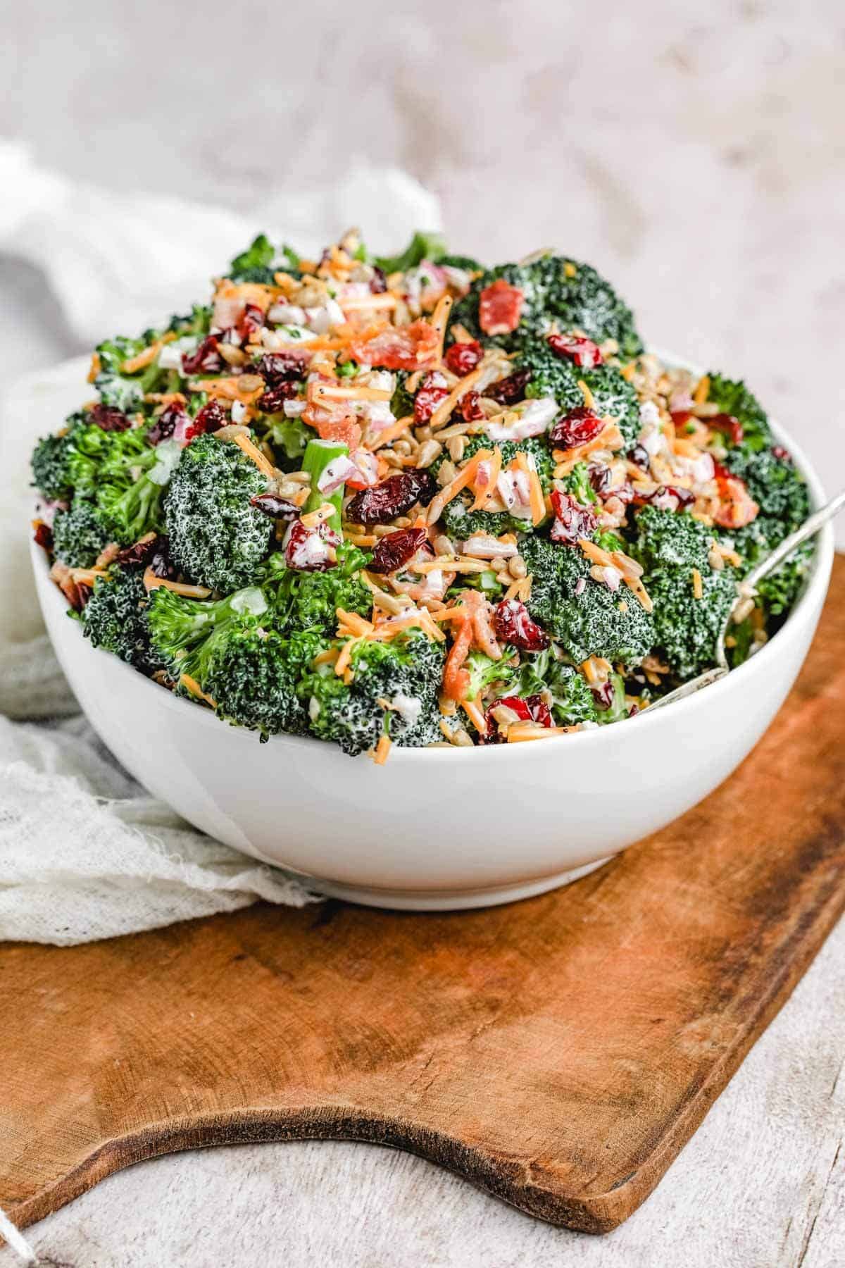 a side shot  up photo the easy broccoli salad in a large serving bowl